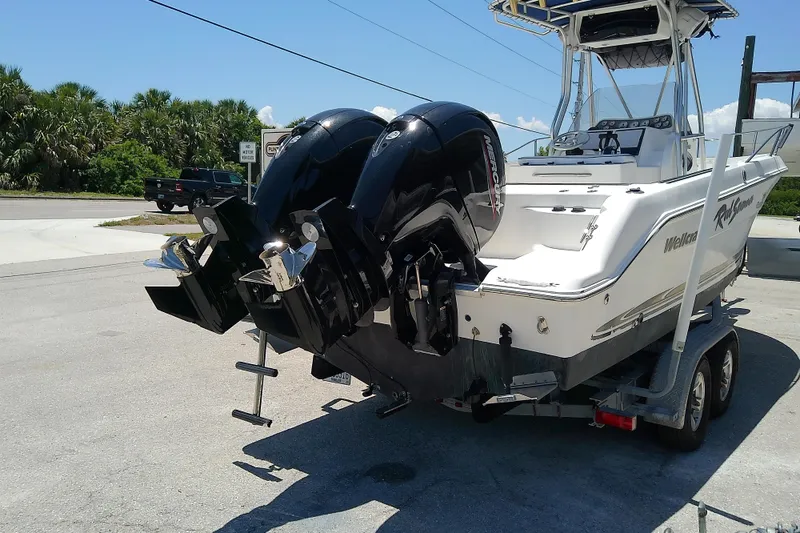Slide: The Image of 2003 Wellcraft 250 Fisherman boat on trailer with dual outboard motors. - 3