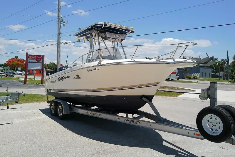 Slide: The Image of 2003 Wellcraft 250 Fisherman boat on trailer in sunny outdoor setting. - 6