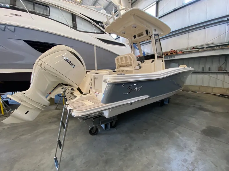 The Image of Scout 220 XSF 2026 boat with Yamaha engine in warehouse. - 0