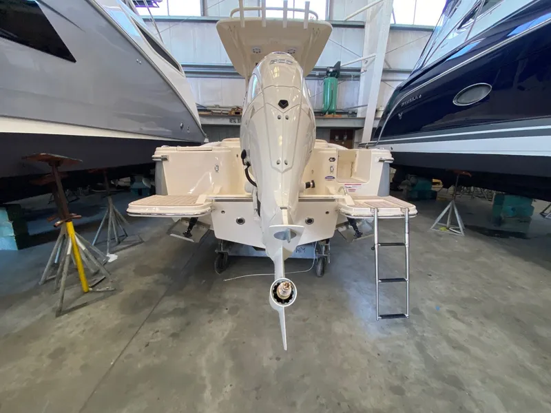 Slide: The Image of Scout 220 XSF 2026 in warehouse with outboard motor. - 2