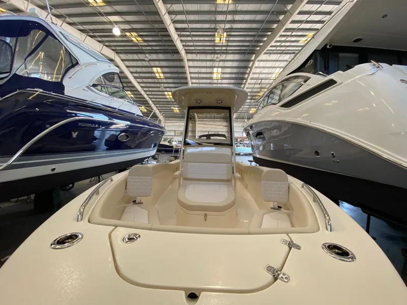 Slide: The Image of Scout 220 XSF 2026 in a boat showroom between two yachts. - 4
