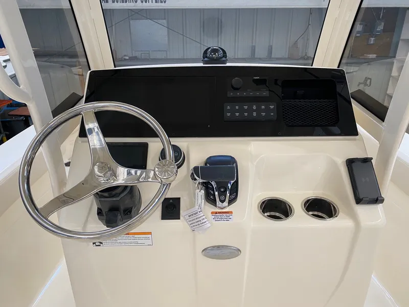 Slide: The Image of 2026 Scout 220 XSF helm with steering wheel and controls. - 7