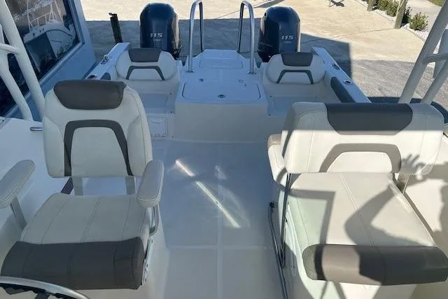 Slide: The Image of 2020 World Cat 230 DC boat interior with seating and dual engines. - 5