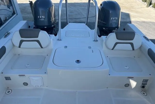 Slide: The Image of 2020 World Cat 230 DC boat interior with dual 115 engines, featuring comfortable seating. - 6
