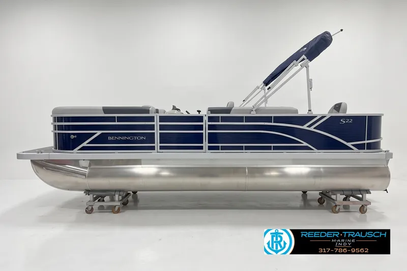 The Image of 2026 Bennington 21 S1FC pontoon boat with blue and silver design in showroom. - 1
