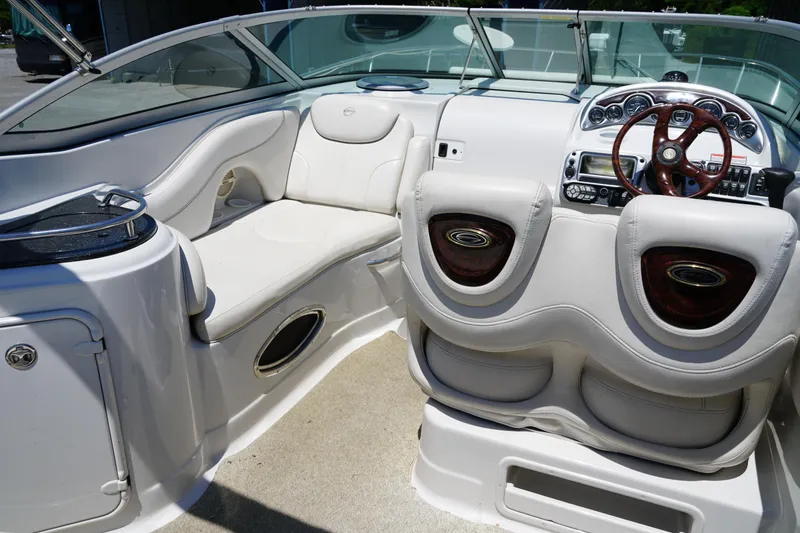 Slide: The Image of Interior of a 2004 Crownline 250 CR boat, featuring plush seating and a sleek dashboard. - 10