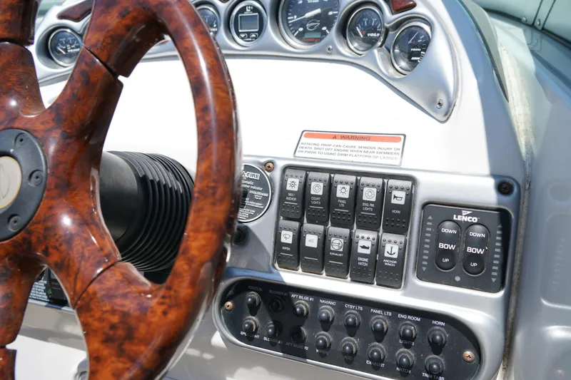 Slide: The Image of Dashboard of a 2004 Crownline 250 CR boat with wood steering wheel and control panel. - 13