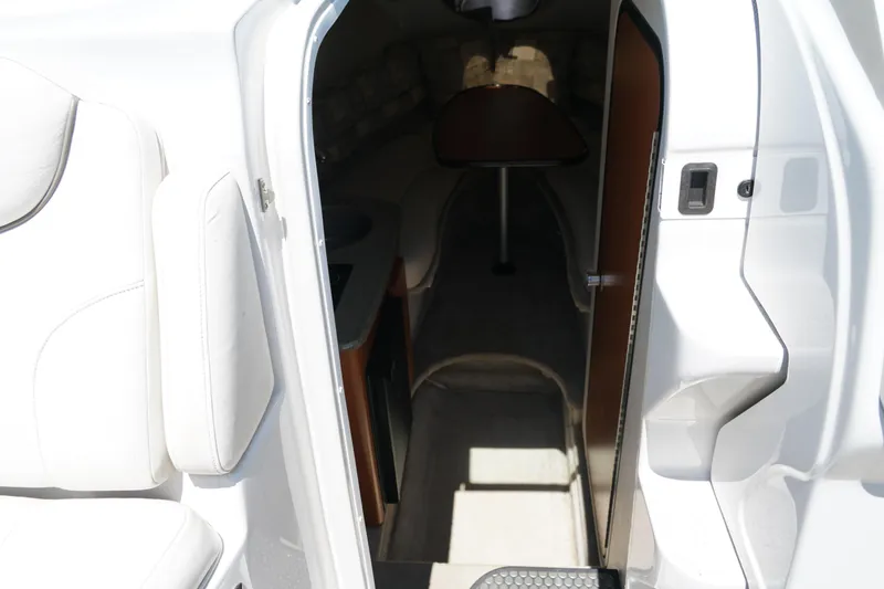 Slide: The Image of Interior cabin view of a 2004 Crownline 250 CR boat, showing seating and entryway. - 16