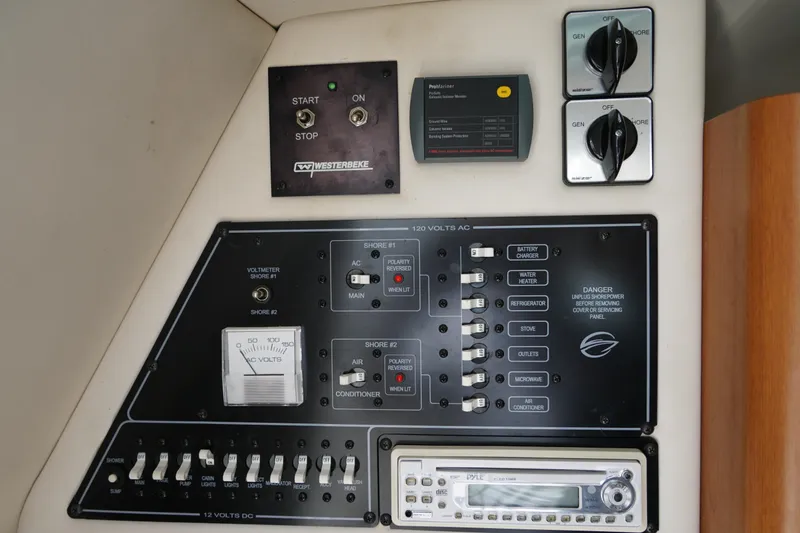 Slide: The Image of Control panel of a 2004 Crownline 250 CR boat with various switches and gauges. - 19