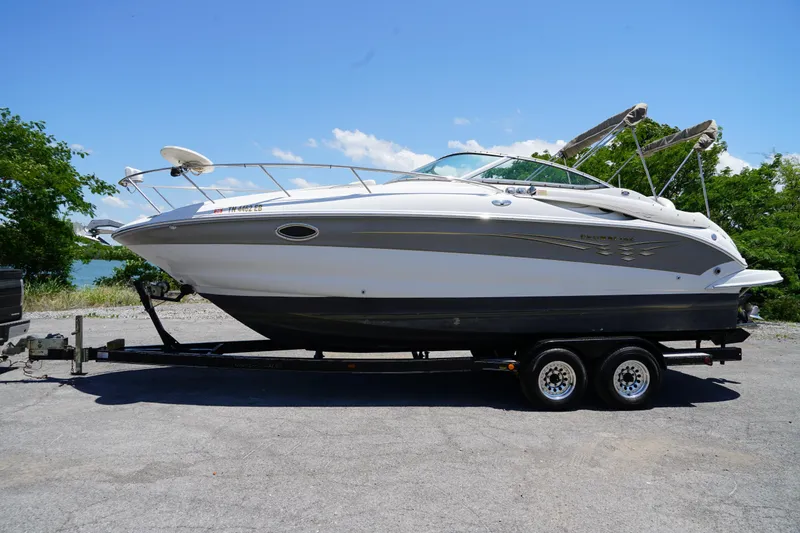 Slide: The Image of 2004 Crownline 250 CR boat on trailer under clear blue sky. - 2