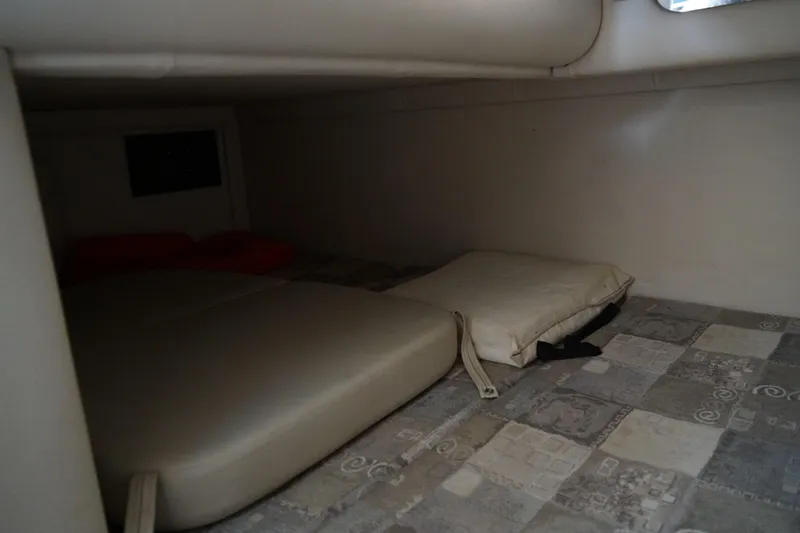 Slide: The Image of 2004 Crownline 250 CR cabin interior with cushions and patterned flooring. - 23