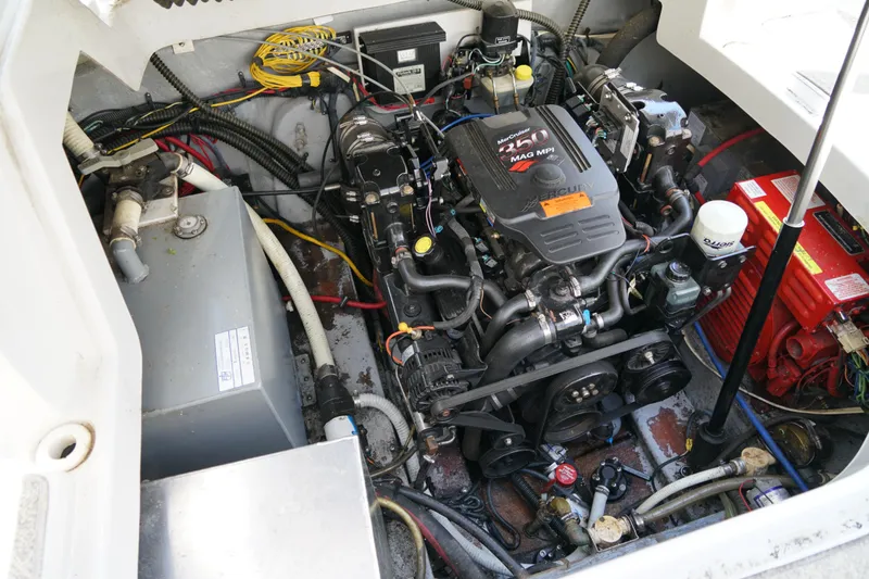 Slide: The Image of Engine compartment of a 2004 Crownline 250 CR boat, featuring a MerCruiser 350 MAG MPI engine. - 25