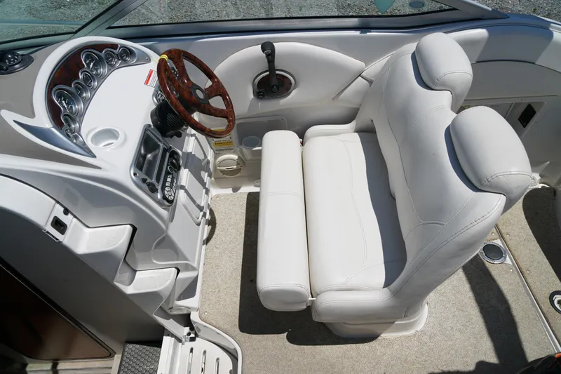 Slide: The Image of 2004 Crownline 250 CR boat interior with white leather seats and wood-accented steering wheel. - 28