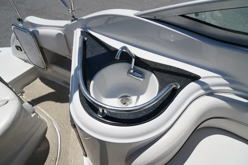 Slide: The Image of 2004 Crownline 250 CR boat interior with a sleek sink and faucet design. - 29