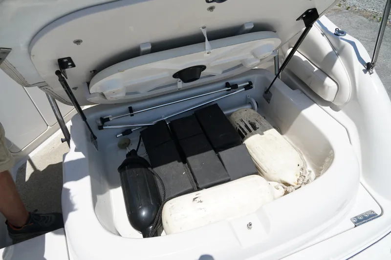 Slide: The Image of Open storage compartment of 2004 Crownline 250 CR boat with fenders and equipment. - 30