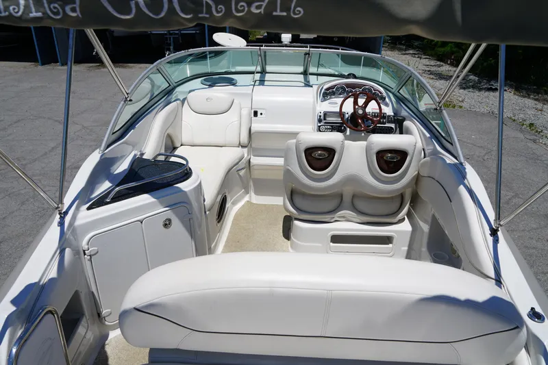 Slide: The Image of 2004 Crownline 250 CR boat interior with white seating and steering wheel. - 5