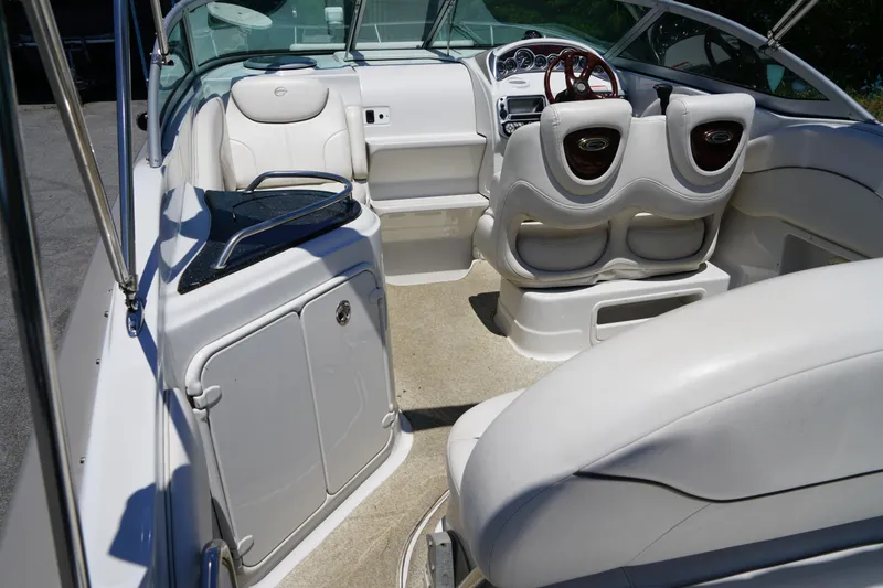 Slide: The Image of 2004 Crownline 250 CR boat interior with white seating and dashboard view. - 6