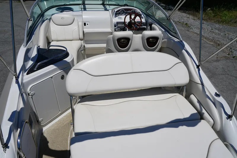 Slide: The Image of 2004 Crownline 250 CR boat interior with white seating and dashboard view. - 7