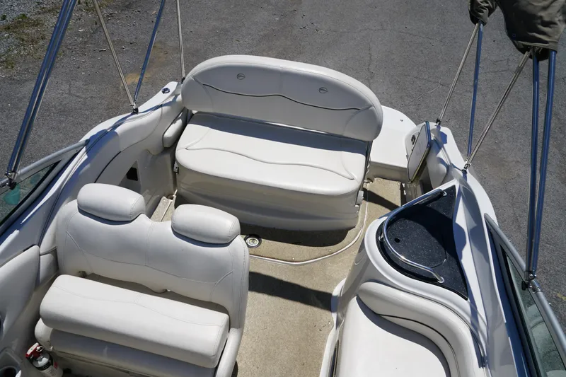 Slide: The Image of 2004 Crownline 250 CR boat interior with white seating and helm area. - 8