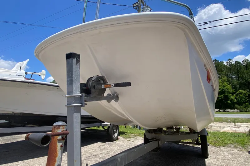 Slide: The Image of 1959 Boston Whaler 13 boat on trailer under clear blue sky. - 10