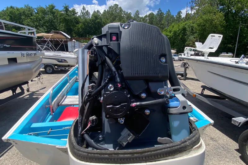 Slide: The Image of 1959 Boston Whaler 13 boat engine close-up, showcasing mechanical details and vibrant blue interior. - 12