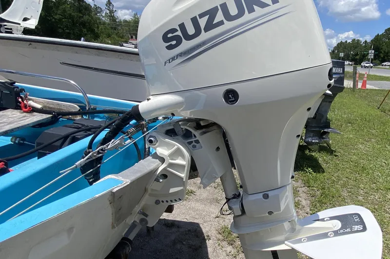 Slide: The Image of Boston Whaler 13 (1959) with Suzuki outboard motor, parked on grass. - 3