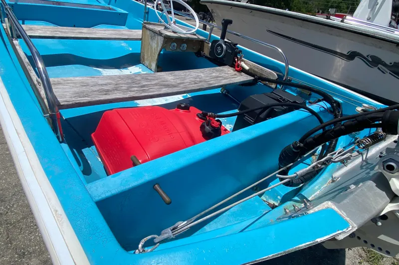 Slide: The Image of 1959 Boston Whaler 13 boat interior with blue hull and red fuel tank. - 4