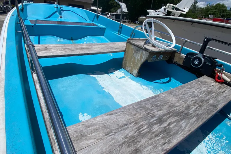 Slide: The Image of 1959 Boston Whaler 13 boat interior with blue hull and wooden seats. - 5