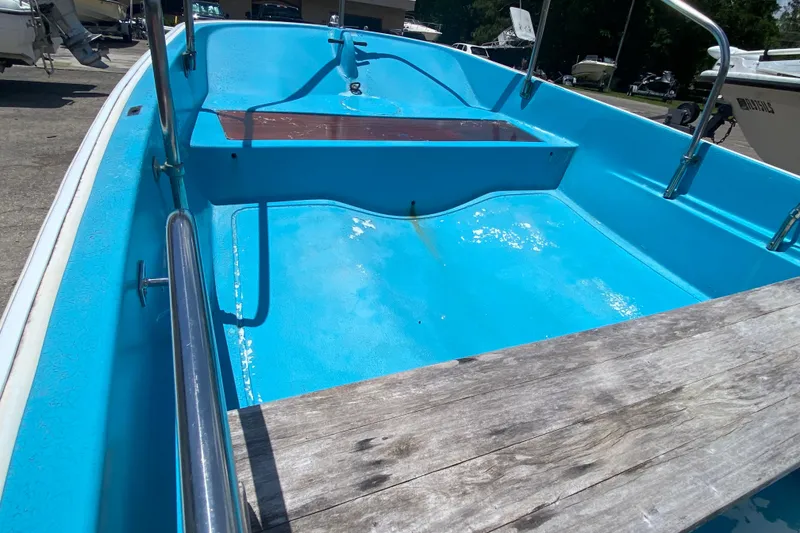 Slide: The Image of 1959 Boston Whaler 13 boat interior with blue hull and wooden seating. - 6