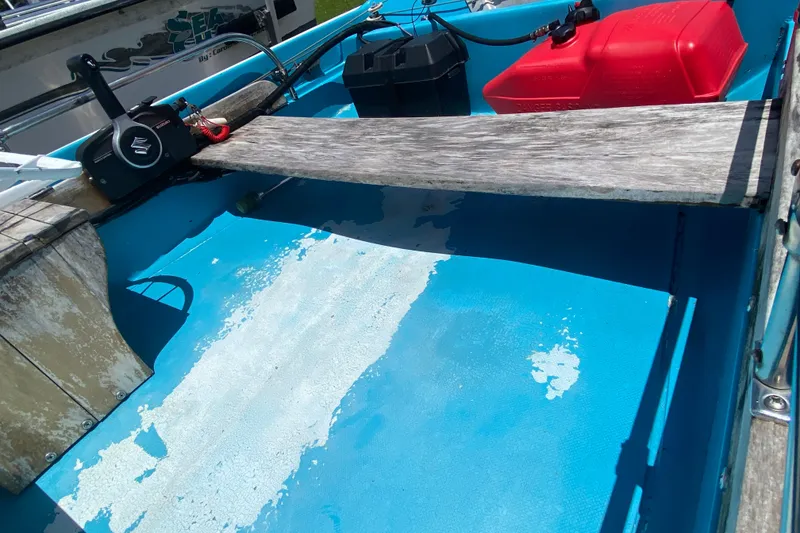 Slide: The Image of Interior of a 1959 Boston Whaler 13 boat with blue flooring and red fuel tank. - 8