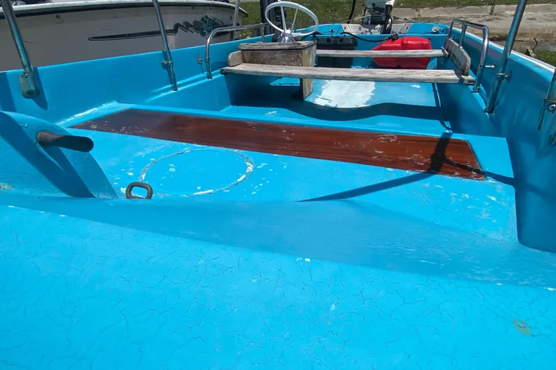 Slide: The Image of 1959 Boston Whaler 13 boat interior with blue paint and wooden accents. - 9