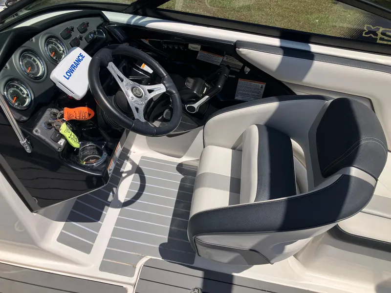 Slide: The Image of Interior of a 2016 Yamaha 212X boat with steering console. - 12