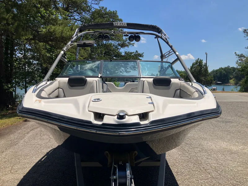 Slide: The Image of 2016 Yamaha Boats 212X on a trailer by the lakeside. - 2