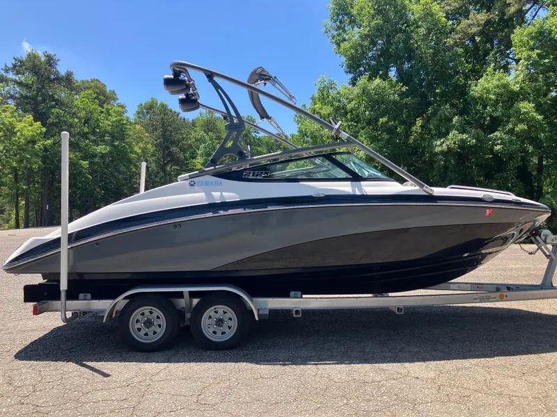Slide: The Image of 2016 Yamaha 212X boat on trailer, surrounded by trees. - 4