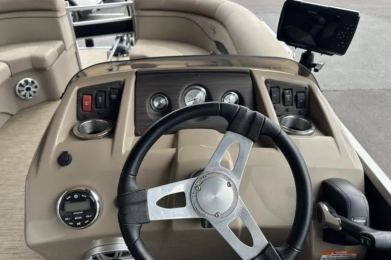 Slide: The Image of 2021 Bennington 20 SSRX boat dashboard with steering wheel and control panel. - 12