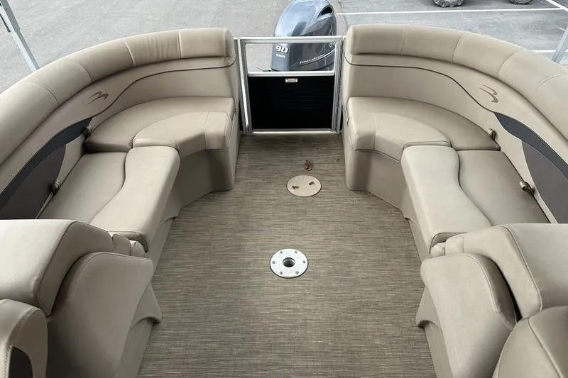 Slide: The Image of Interior of a 2021 Bennington 20 SSRX pontoon boat with beige seating. - 2