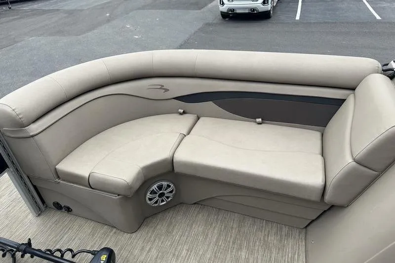 Slide: The Image of 2021 Bennington 20 SSRX boat interior with beige seating and speaker. - 5