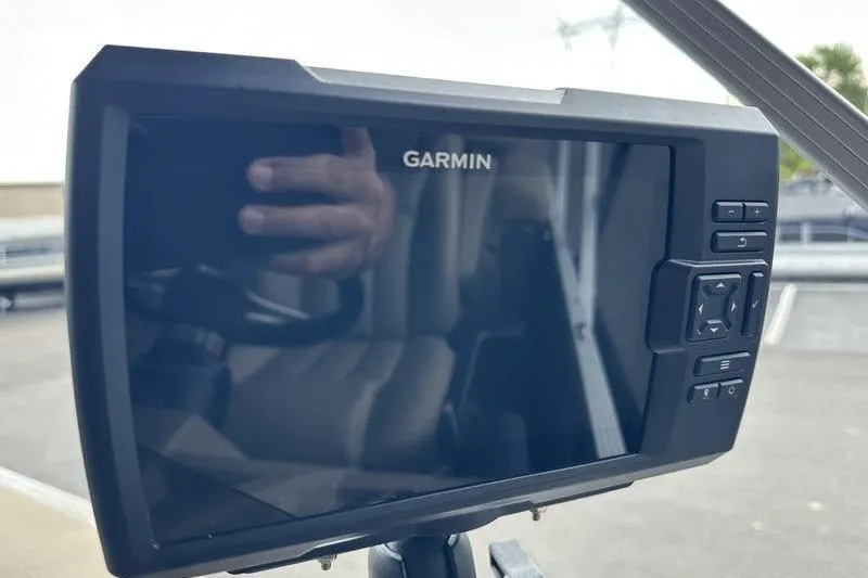 Slide: The Image of Garmin display on 2021 Bennington 20 SSRX boat, showing control buttons and reflection. - 7
