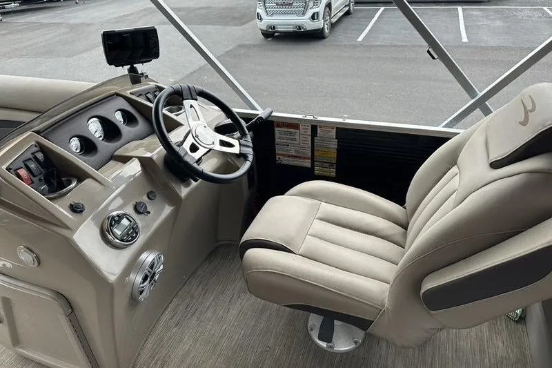 Slide: The Image of Interior of a 2021 Bennington 20 SSRX boat with steering wheel and captain's chair. - 8