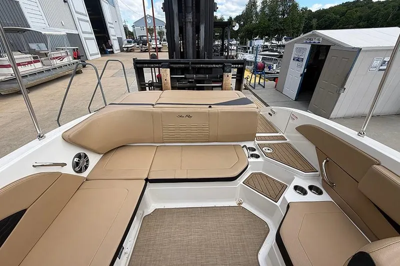 Slide: The Image of Interior of 2021 Sea Ray SPX 210 boat with tan seating and wood accents. - 10