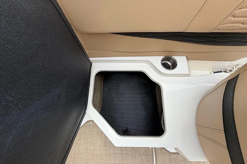 Slide: The Image of 2021 Sea Ray SPX 210 boat interior storage compartment with beige seating. - 14