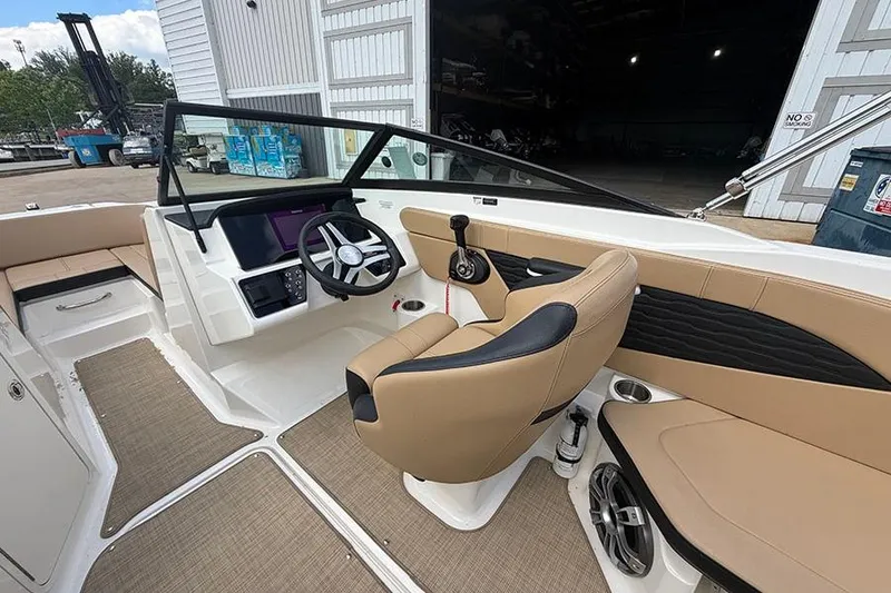 Slide: The Image of Interior view of 2021 Sea Ray SPX 210 boat with tan seating and modern dashboard. - 16