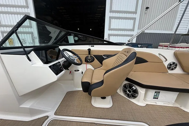 Slide: The Image of 2021 Sea Ray SPX 210 boat interior with tan seating and modern dashboard. - 17