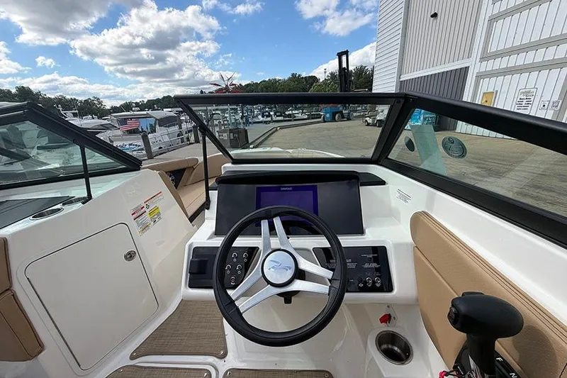 Slide: The Image of 2021 Sea Ray SPX 210 boat dashboard with steering wheel and control panel. - 18