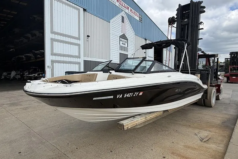 Slide: The Image of 2021 Sea Ray SPX 210 boat on forklift at marina entrance. - 2