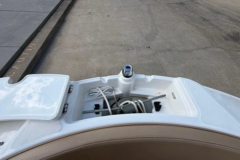 Slide: The Image of 2021 Sea Ray SPX 210 boat anchor storage compartment with ropes and anchor. - 24