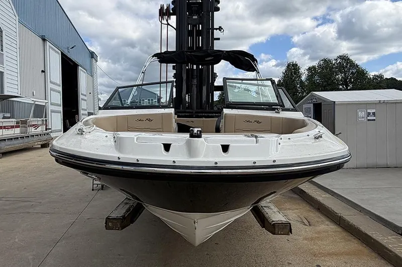 Slide: The Image of 2021 Sea Ray SPX 210 boat on a forklift at a marina. - 3