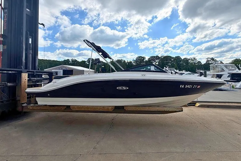 Slide: The Image of 2021 Sea Ray SPX 210 boat on a lift, under a partly cloudy sky. - 5