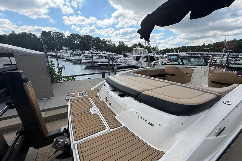 Slide: The Image of 2021 Sea Ray SPX 210 boat docked at marina with clear skies. - 6
