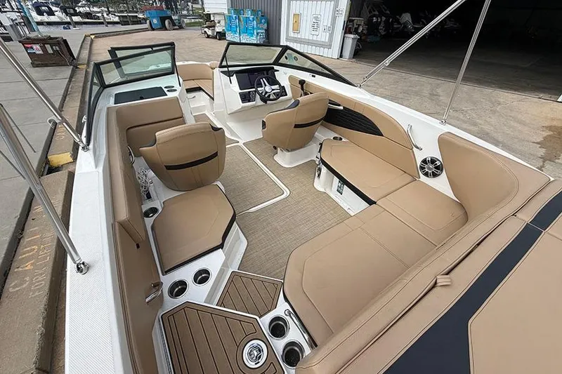 Slide: The Image of 2021 Sea Ray SPX 210 boat interior with tan seating and modern dashboard. - 9